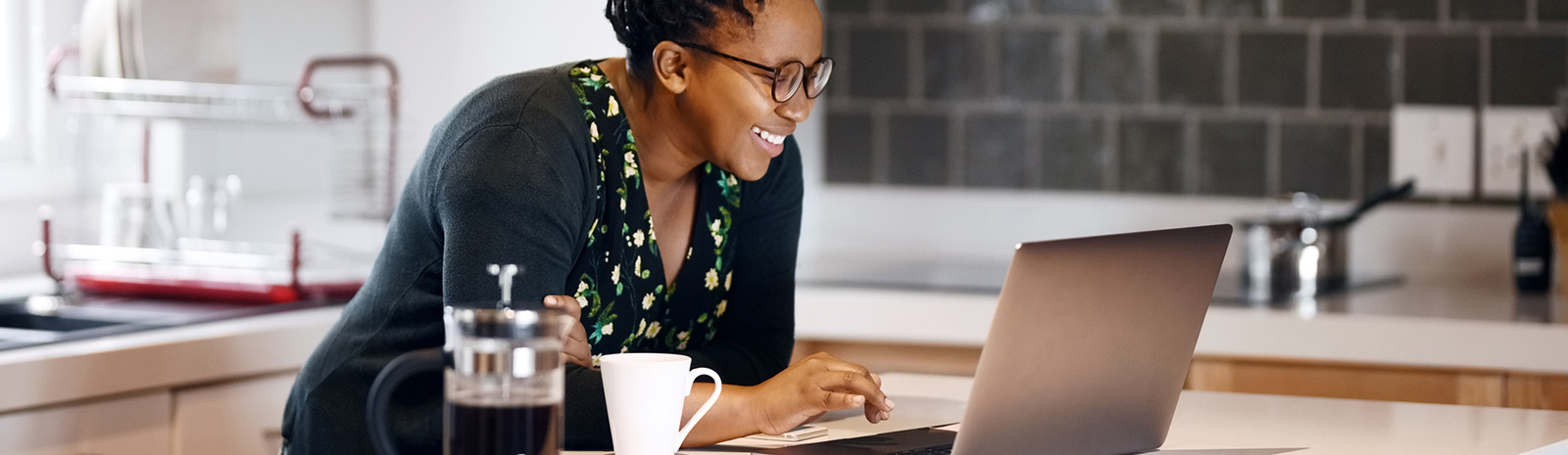 woman looking at laptop in kitchen