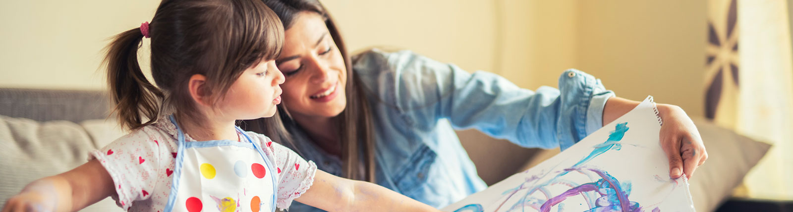 Mother and daughter enjoying artwork in living room