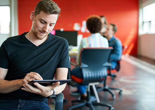 Business owner looking at tablet in office